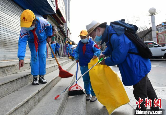 圖為拉薩市小學(xué)生打掃街道?！∝暩聛硭?攝