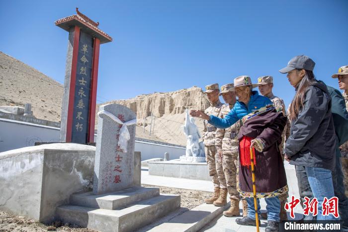 圖為在西藏阿里地區(qū)札達縣烈士陵園，82歲的次仁南杰老人為軍民代表講述新舊西藏的變化?！詵| 攝